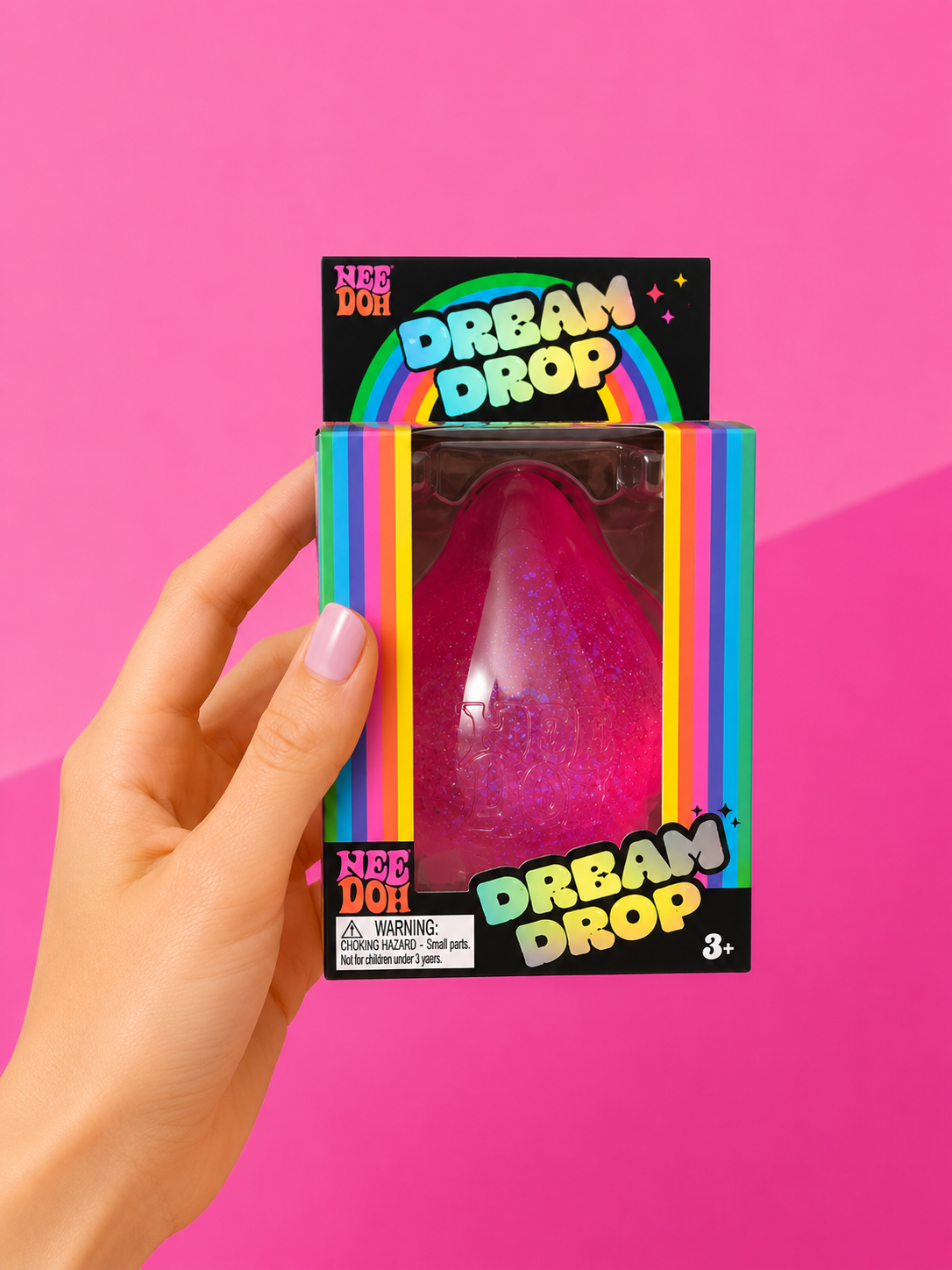 NeeDoh Dream Drop sensory fidget toy in a pink teardrop shape resting on its removable matching splash display stand